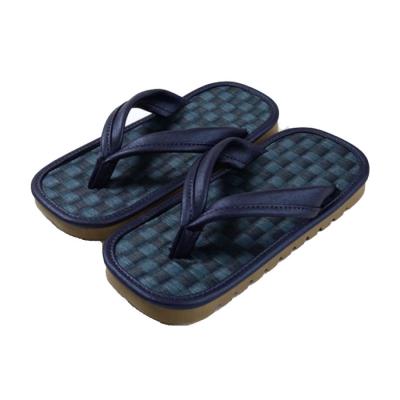 Close-up of the checkered footbed on navy blue traditional Japanese sandals.